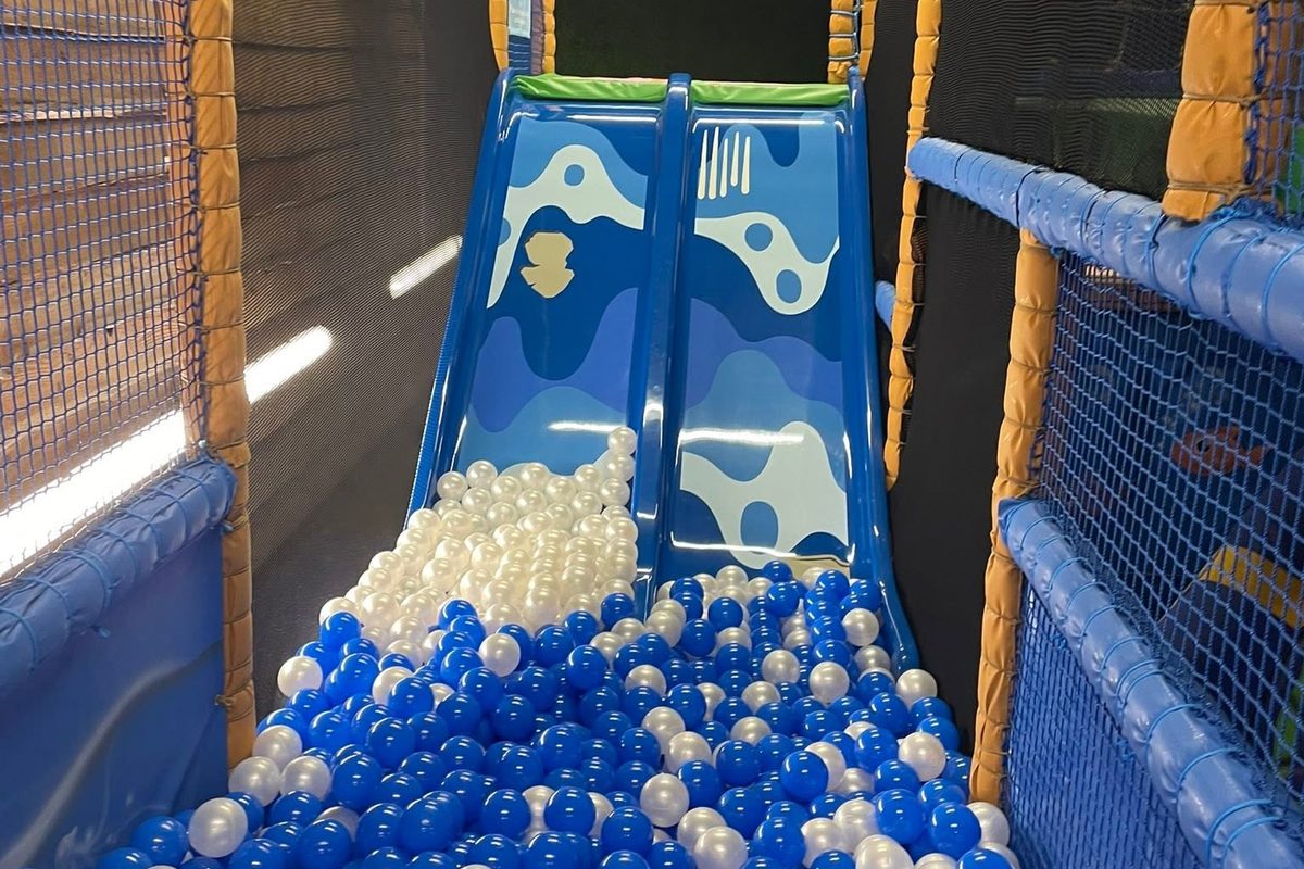 The Griffin Bach slide pouring into the blue and white ball pit