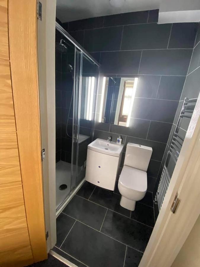 A modern black-tiled shower room